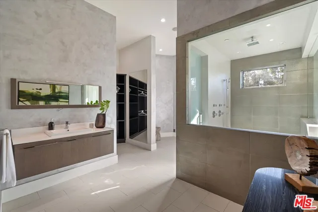a living room with stainless steel appliances kitchen island granite countertop a sink and cabinets