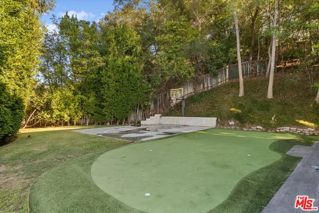 a view of a playground with basketball court
