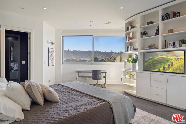 a bedroom with a bed and window