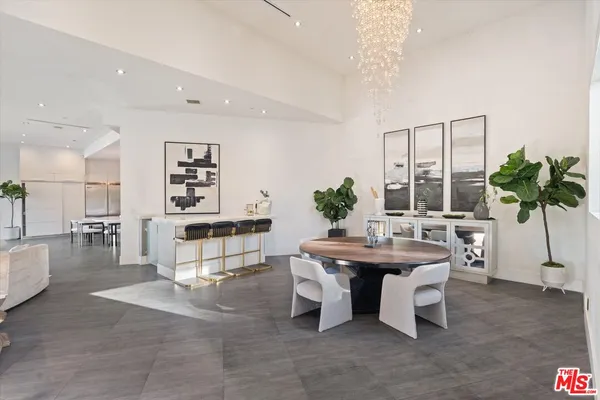 a living room with furniture a potted plant and a table