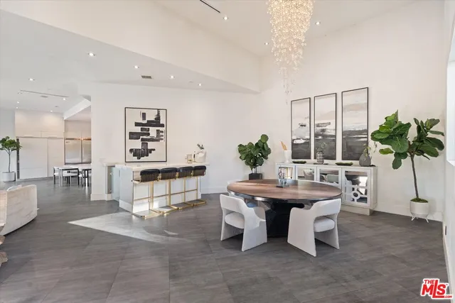 a living room with furniture a potted plant and a table