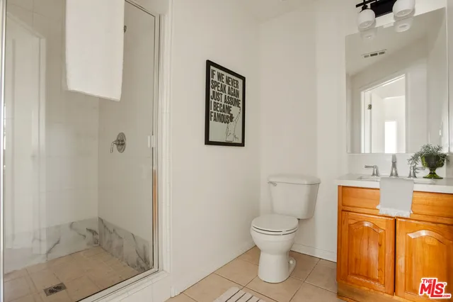 a bathroom with a toilet a sink and shower