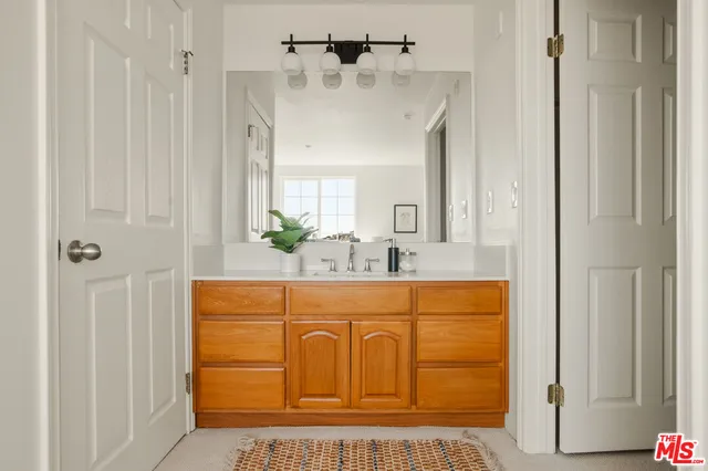 a bathroom with a sink a mirror and a shower