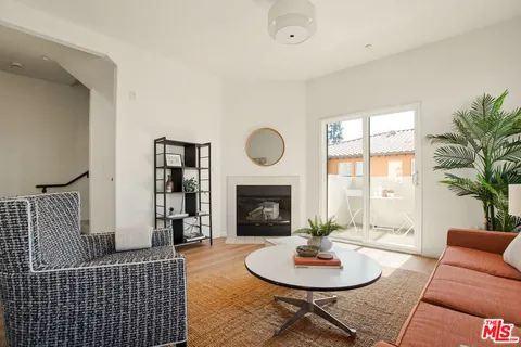 a living room with furniture a window and a fireplace
