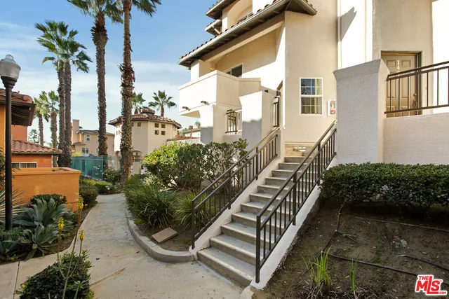 a view of a yard with potted plants