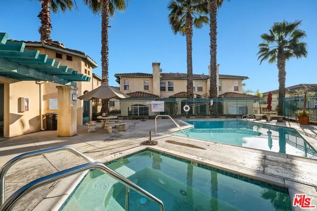 a view of a swimming pool with a table and chairs