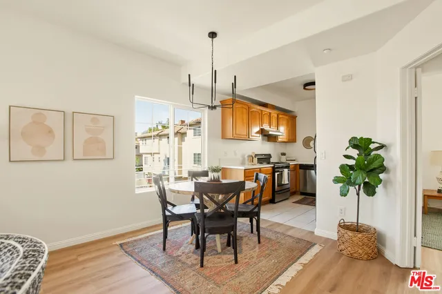 a view of a dining room with furniture and a chandelier