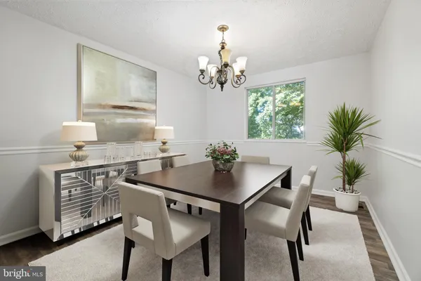 a view of a dining room with furniture and chandelier