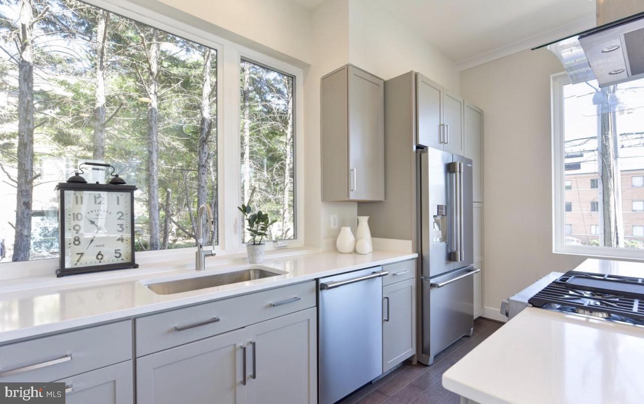 2815 24th Road South Arlington, VA 22206 - Photo 11 of 27 a kitchen with stainless steel appliances a sink cabinets and a large window