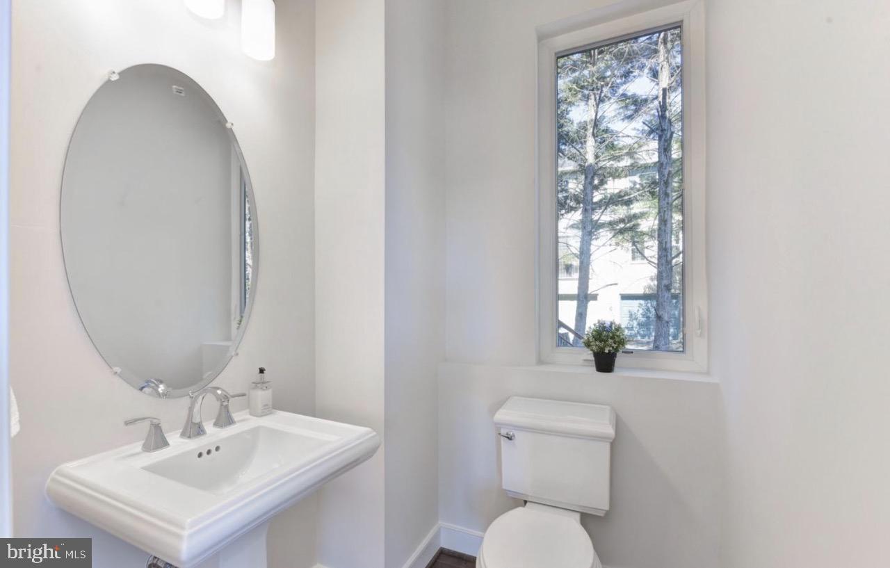 2815 24th Road South Arlington, VA 22206 - Photo 12 of 27 a bathroom with a toilet sink and mirror