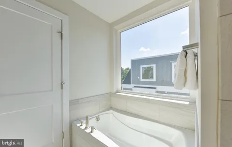 a view of an empty walk in closet with wooden floor