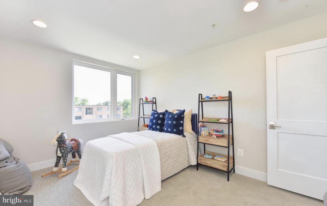2815 24th Road South Arlington, VA 22206 - Photo 21 of 27 a bedroom with a bed a table and a large window
