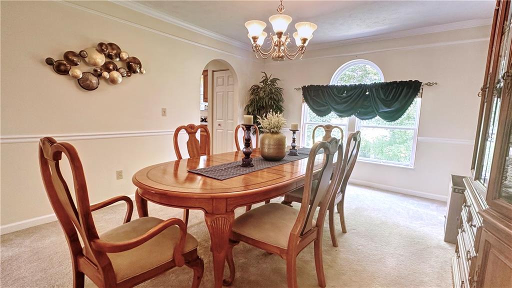 440 Chapeldale Drive Apollo, PA 15613 - Photo 11 of 48 a view of a dining room with furniture a chandelier and wooden floor