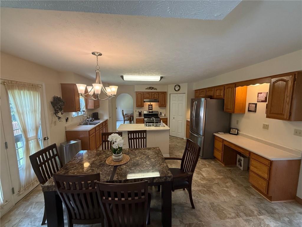 440 Chapeldale Drive Apollo, PA 15613 - Photo 12 of 48 a dining room with furniture a chandelier and window