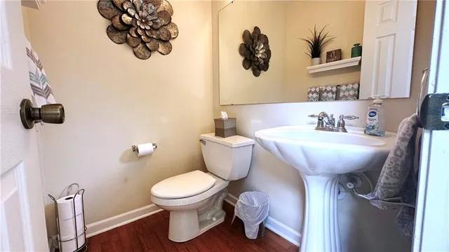 a bathroom with a toilet sink and mirror