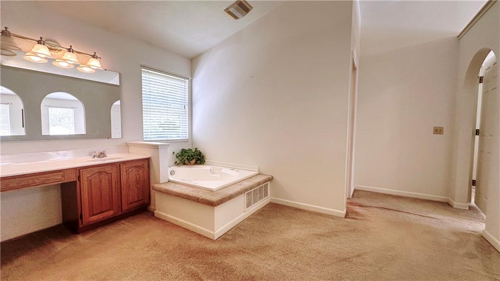 440 Chapeldale Drive Apollo, PA 15613 - Photo 22 of 48 a spacious bathroom with a double vanity sink a mirror and a bathtub