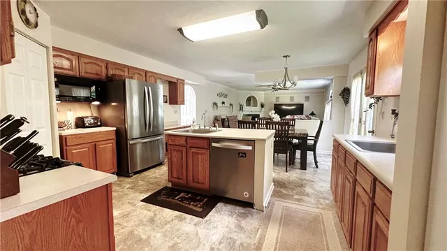 a kitchen with stainless steel appliances a stove a sink dishwasher and a refrigerator