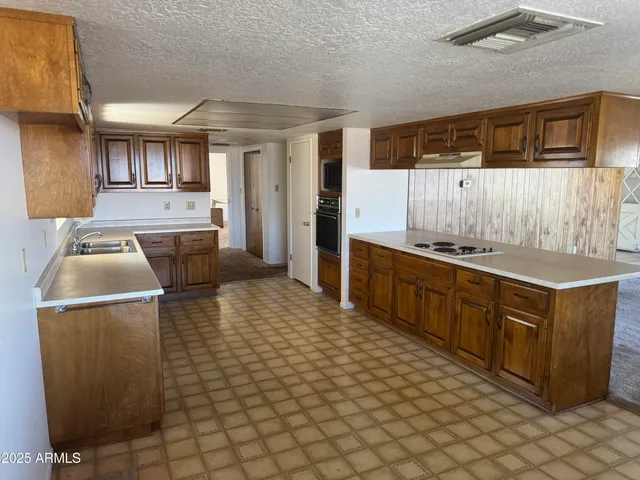 a kitchen with stainless steel appliances granite countertop a sink and cabinets
