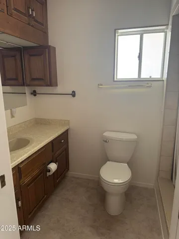 a bathroom with a toilet sink and mirror