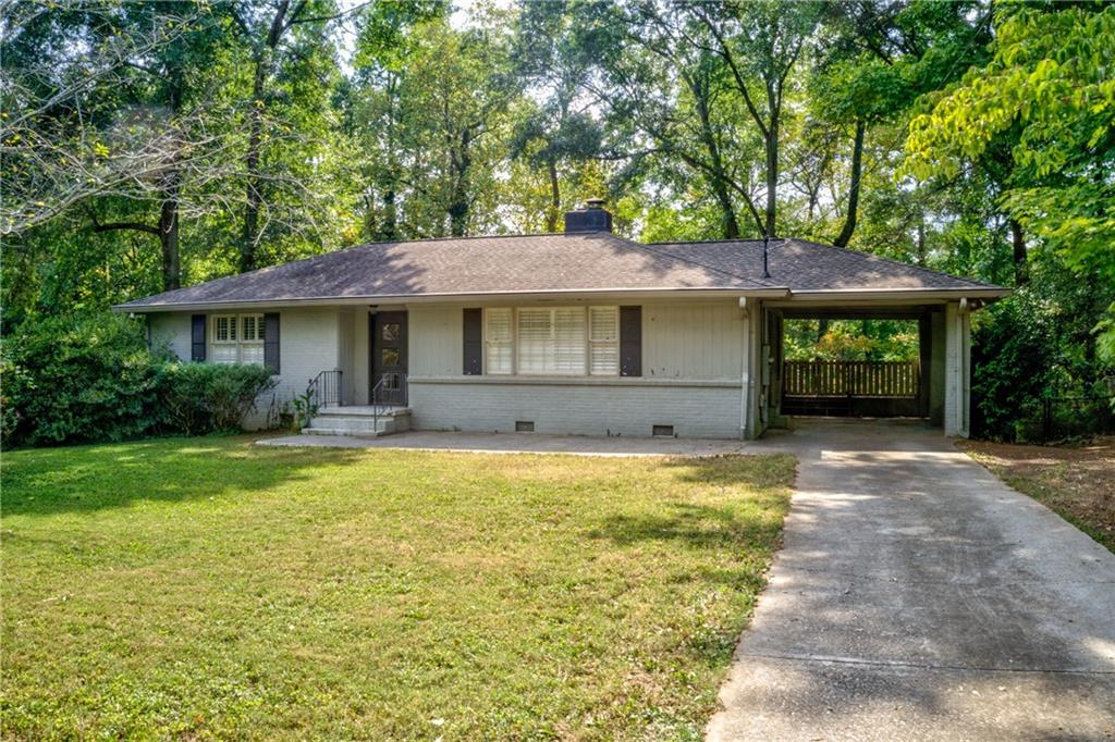 127 Spring Drive Roswell, GA 30075 - Photo 1 of 1 a front view of a house with a garden