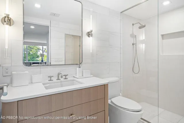 a bathroom with a sink toilet and shower