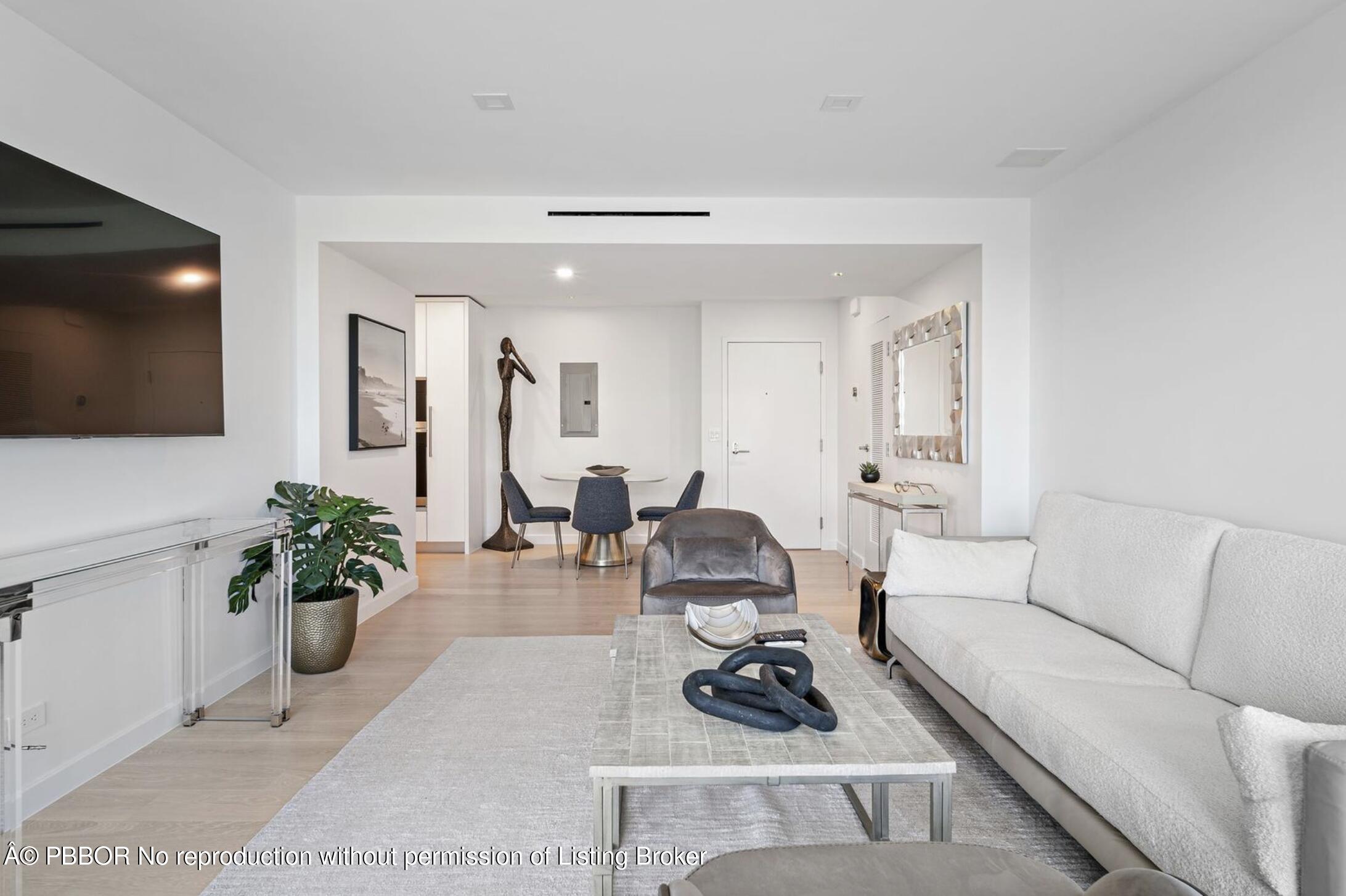 333 Sunset Avenue, Unit 512 Palm Beach, FL 33480 - Photo 5 of 29 a living room with furniture potted plant and a flat screen tv