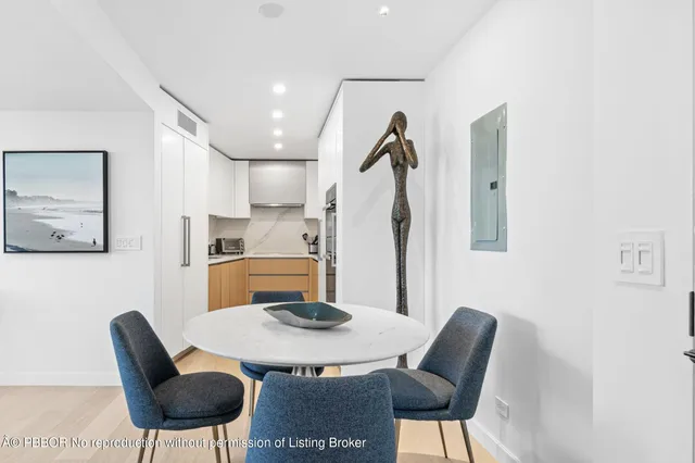 a kitchen with stainless steel appliances kitchen island granite countertop a kitchen island and chairs in it