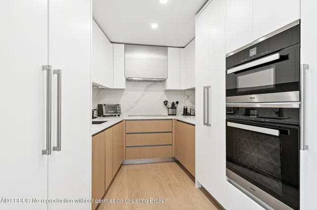a kitchen with stainless steel appliances white cabinets and a stove