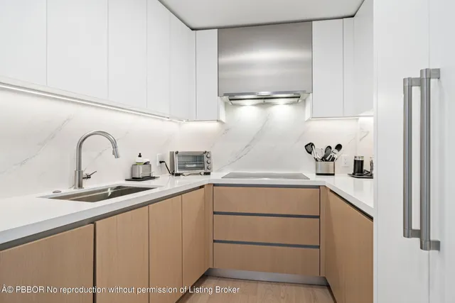a kitchen with cabinets a sink and appliances