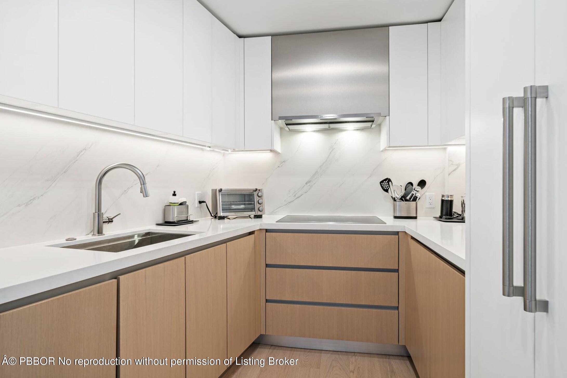 333 Sunset Avenue, Unit 512 Palm Beach, FL 33480 - Photo 9 of 29 a kitchen with cabinets a sink and appliances