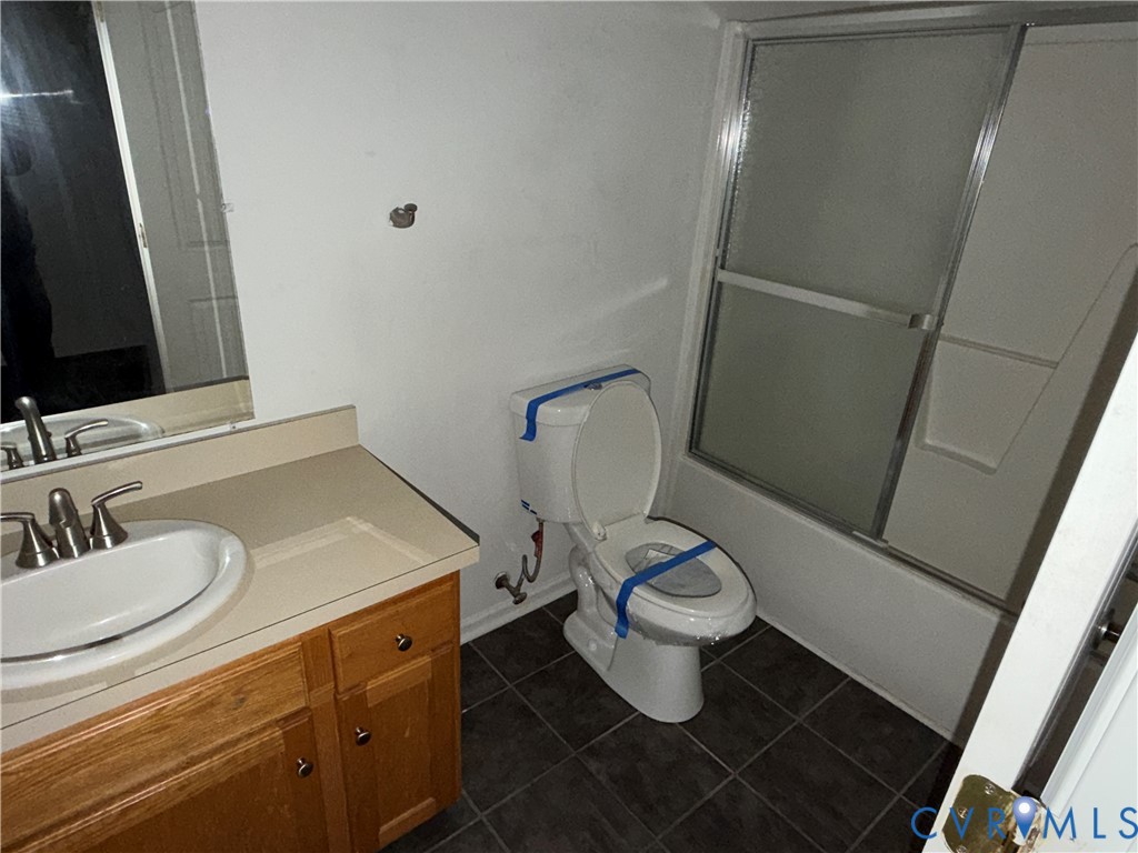 117 Pleasant Spring Avenue Waverly, VA 23890 - Photo 9 of 12 a bathroom with a sink toilet and mirror