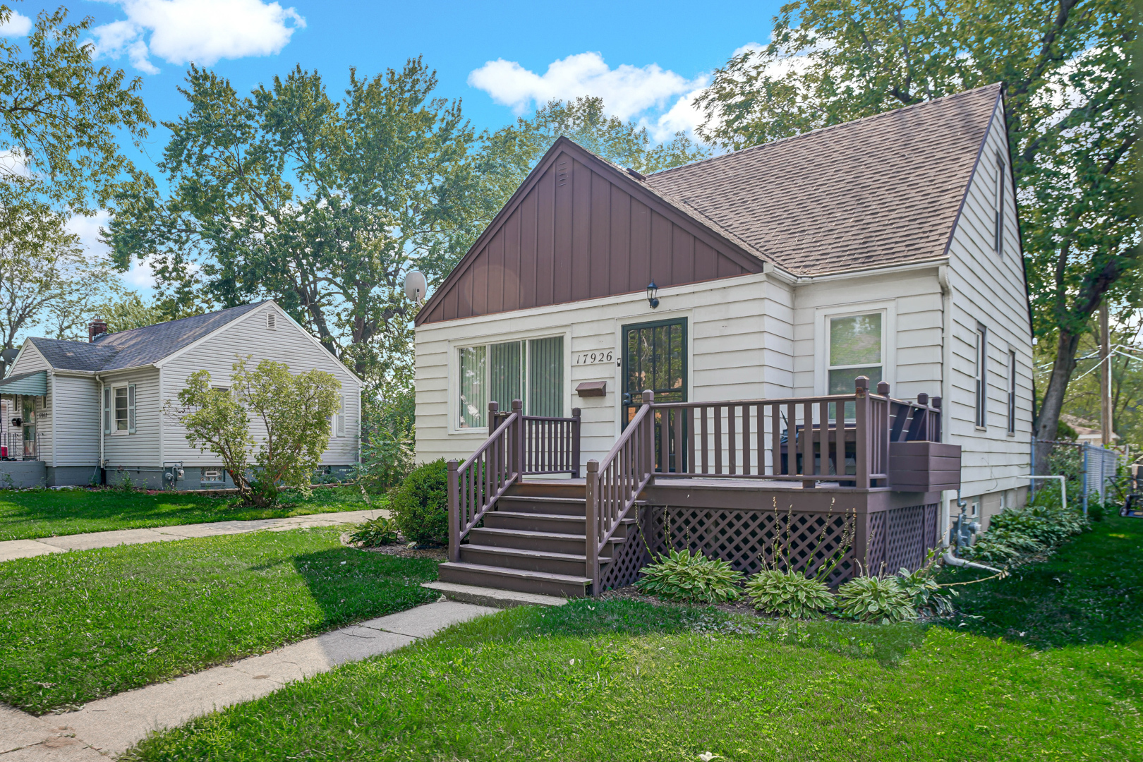 a view of a house with a backyard and a garden