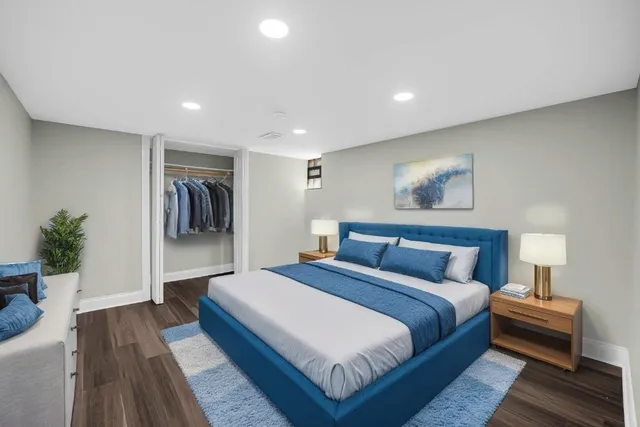 a spacious bedroom with a bed and a couch