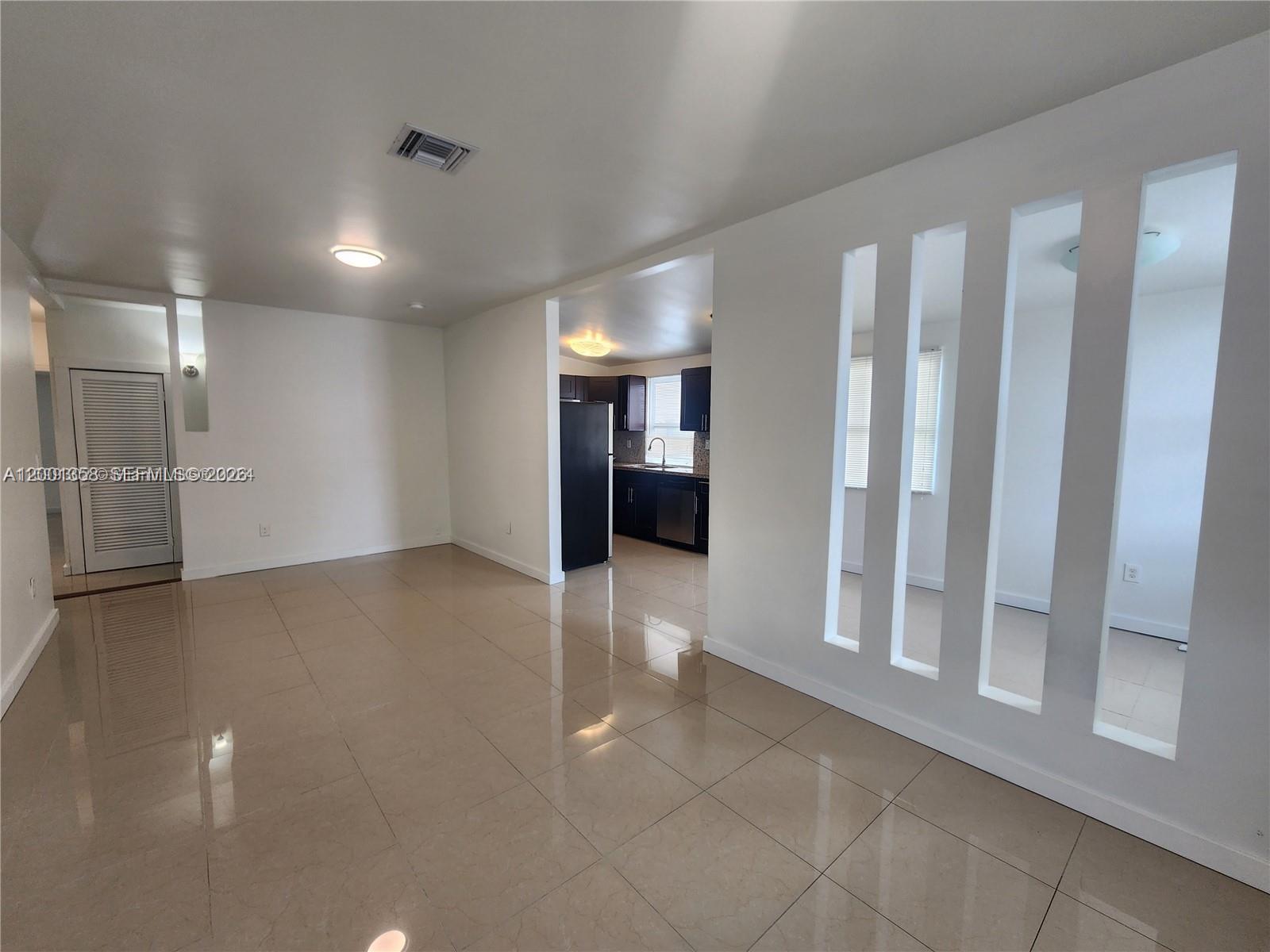 1726 Southwest 25th Avenue, Unit 1 Miami, FL 33145 - Photo 2 of 14 a view of an empty room with a fireplace