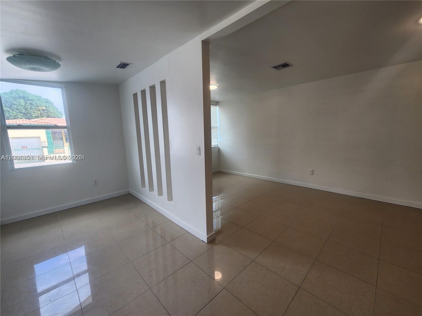 1726 Southwest 25th Avenue, Unit 1 Miami, FL 33145 - Photo 5 of 14 an empty room with windows