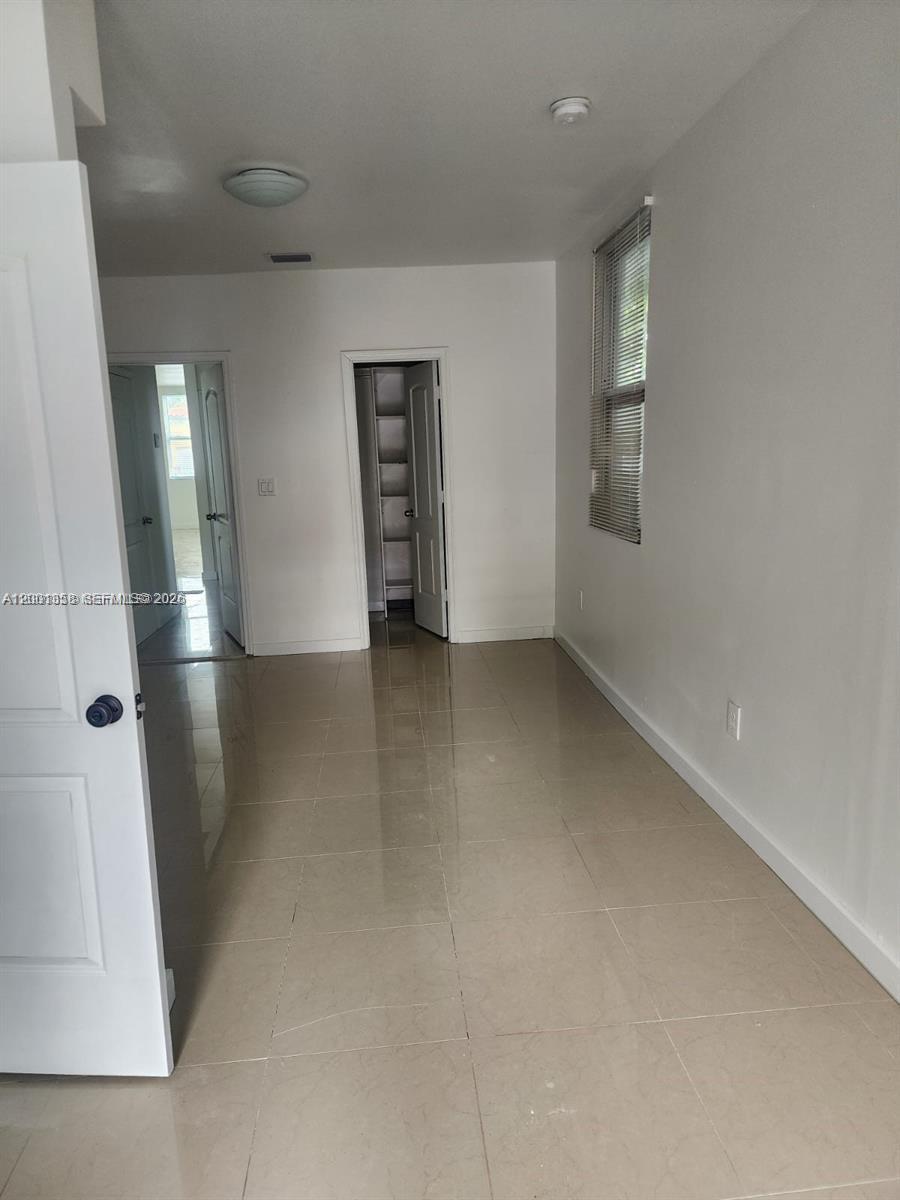 1726 Southwest 25th Avenue, Unit 1 Miami, FL 33145 - Photo 6 of 14 an empty room with windows