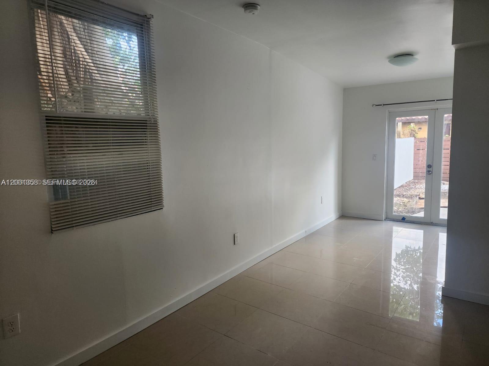 1726 Southwest 25th Avenue, Unit 1 Miami, FL 33145 - Photo 8 of 14 a view of livingroom and window