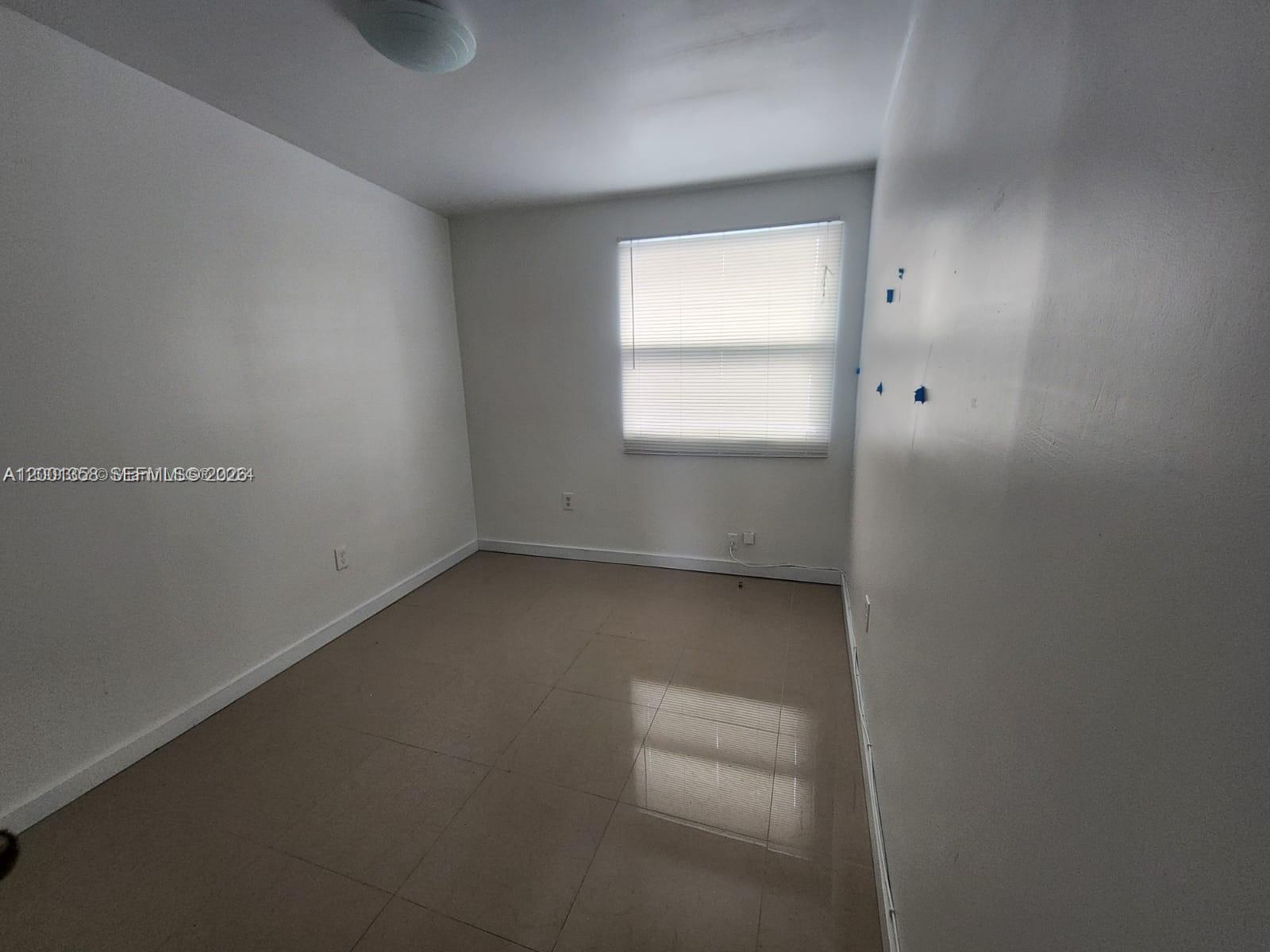 1726 Southwest 25th Avenue, Unit 1 Miami, FL 33145 - Photo 9 of 14 an empty room with a window