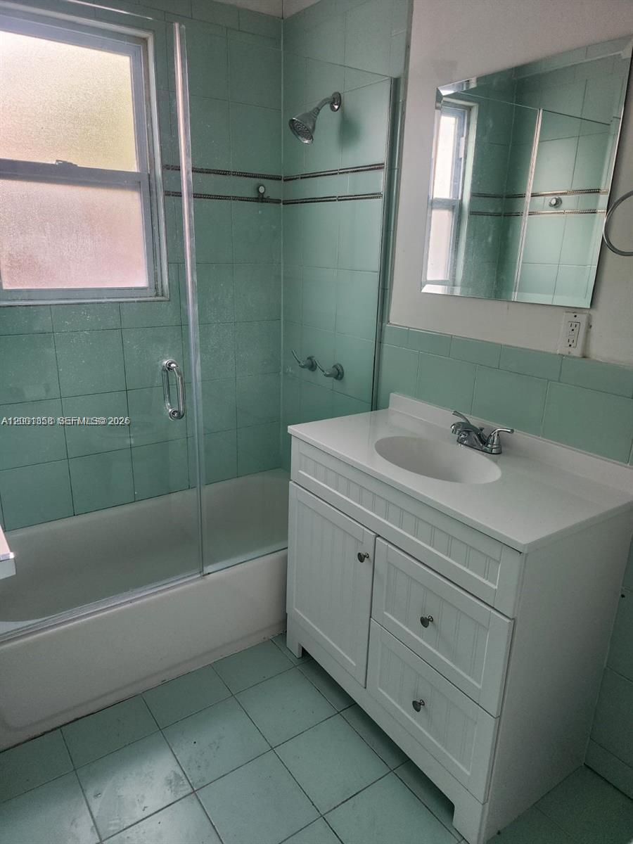 1726 Southwest 25th Avenue, Unit 1 Miami, FL 33145 - Photo 10 of 14 a bathroom with a bathtub a sink and a mirror