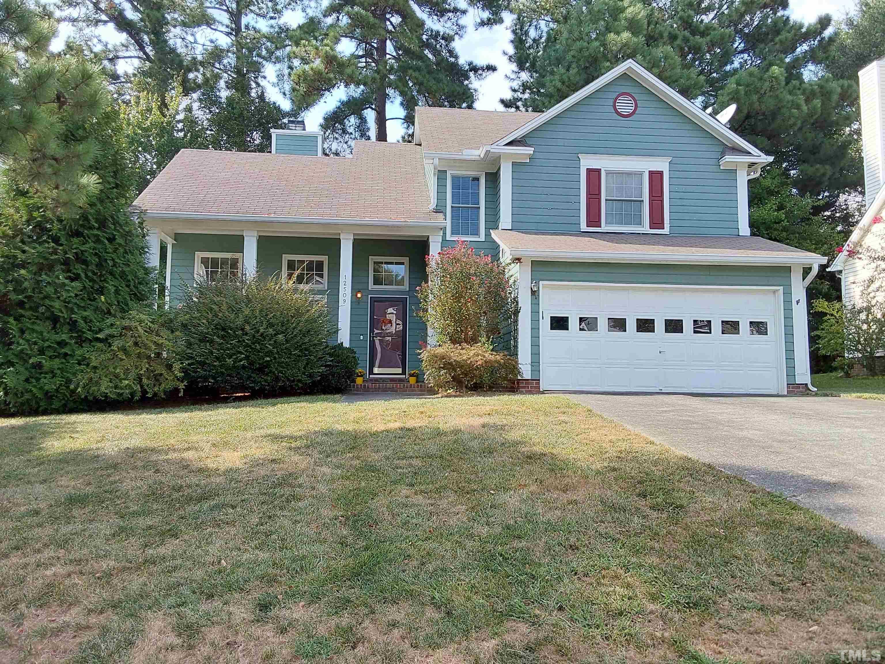 12509 Harcourt Drive Raleigh, NC 27613 - Photo 1 of 32 a front view of a house with a yard and garage