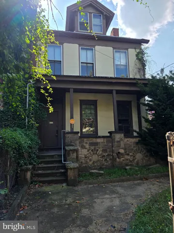 a view of a house with brick walls and plants