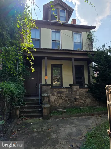 a view of a house with brick walls and plants