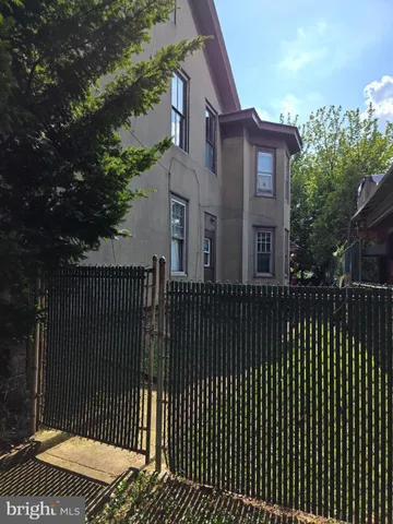 a view of a brick house with a large window