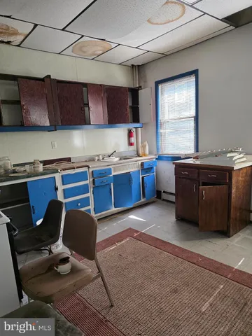 a kitchen with a table chairs and a wooden cabinets