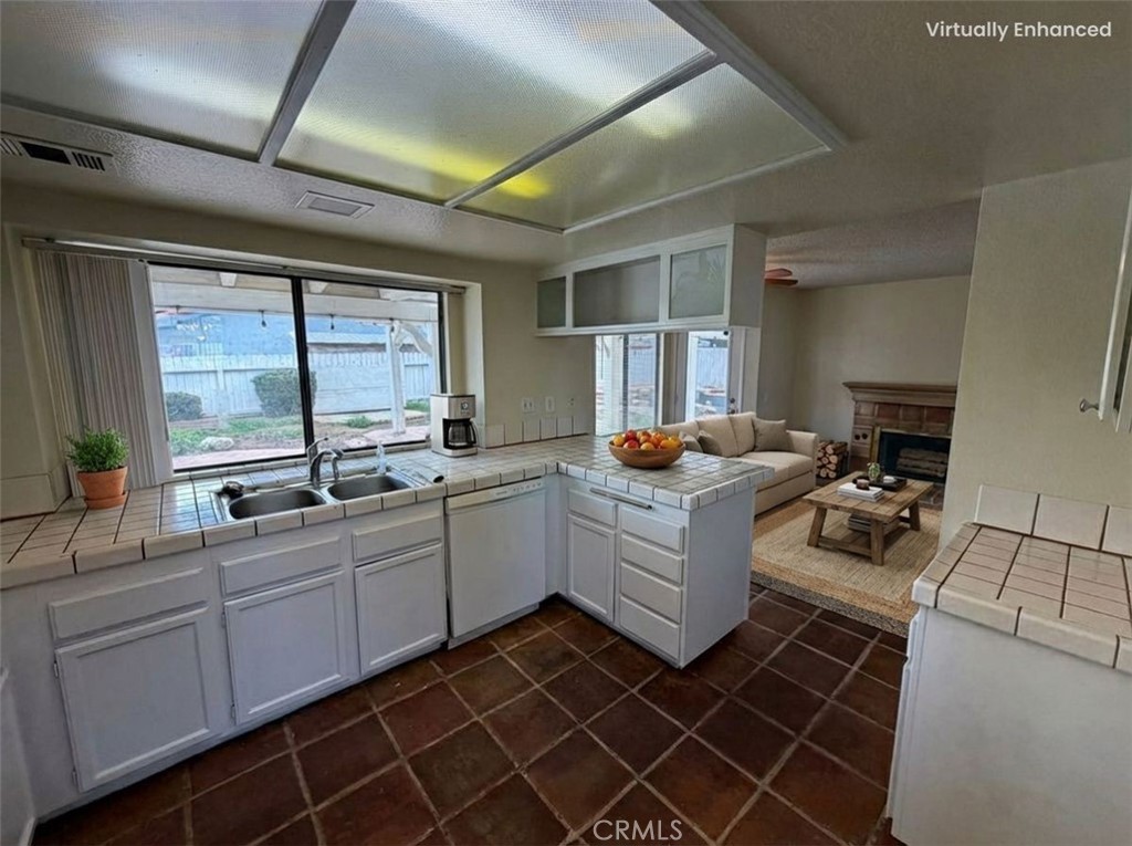 2560 East Ave R12 Palmdale, CA 93550 - Photo 12 of 26 a kitchen with a sink and wooden cabinets