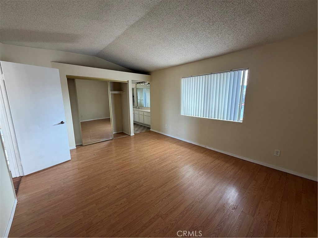 2560 East Ave R12 Palmdale, CA 93550 - Photo 20 of 26 an empty room with wooden floor and windows