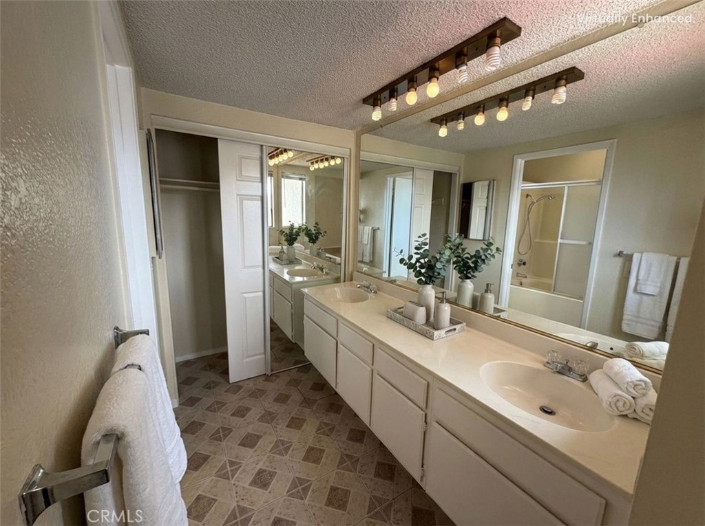 2560 East Ave R12 Palmdale, CA 93550 - Photo 22 of 26 a bathroom with a double vanity sink mirror and toilet