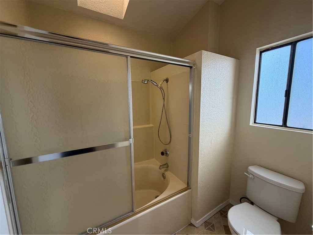 2560 East Ave R12 Palmdale, CA 93550 - Photo 23 of 26 a bathroom with a toilet and a shower