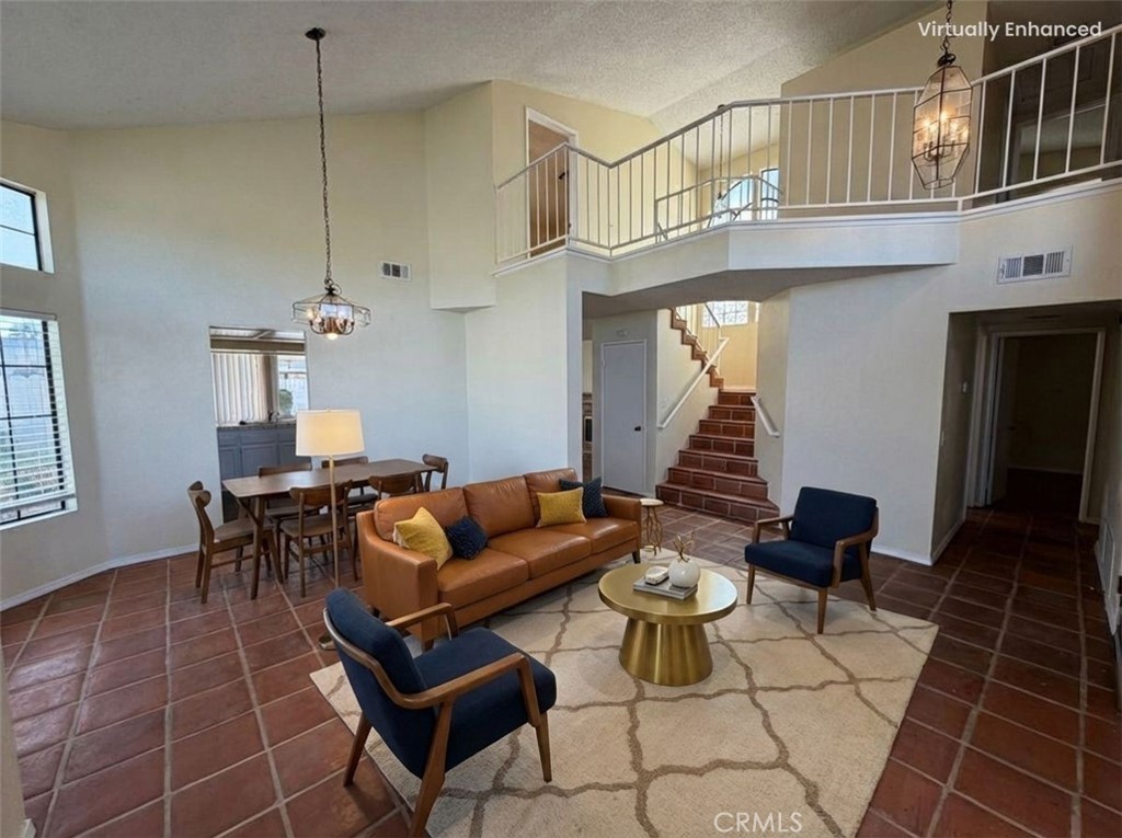 2560 East Ave R12 Palmdale, CA 93550 - Photo 4 of 26 a living room with furniture a rug and white walls