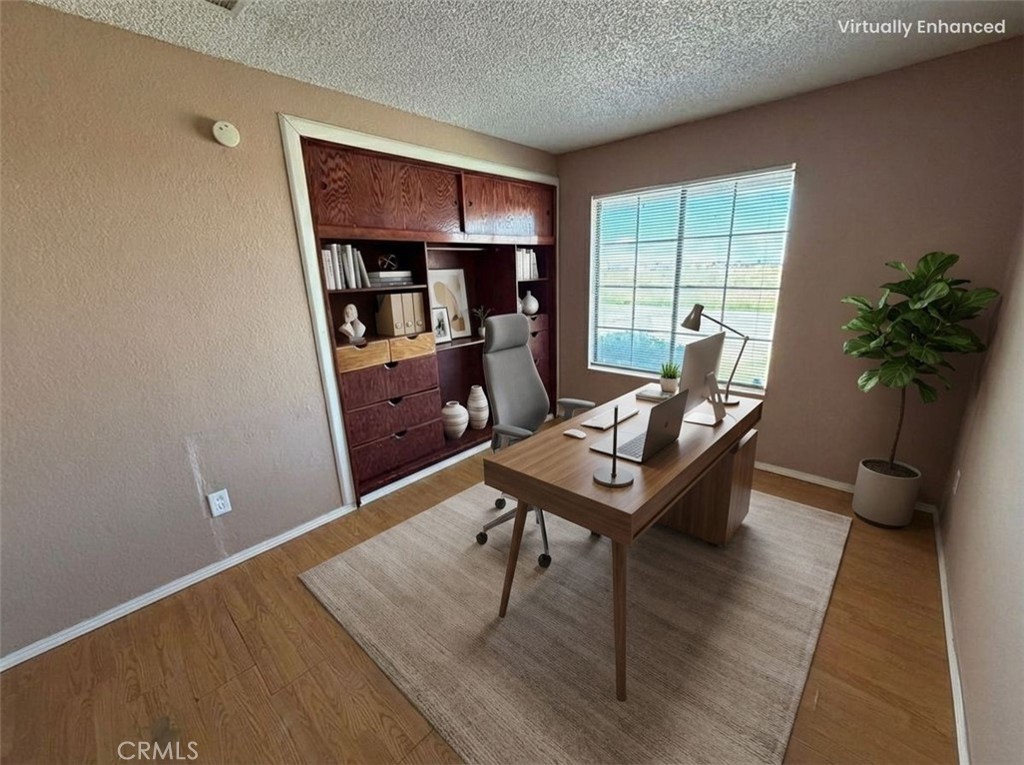 2560 East Ave R12 Palmdale, CA 93550 - Photo 6 of 26 a living room with furniture and a potted plant